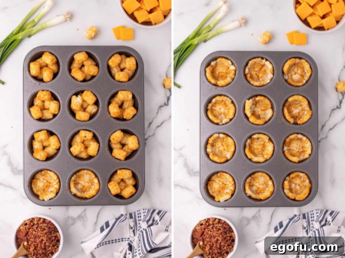 A hand using the back of a spoon to gently smash baked tater tots in a muffin pan to create a cup shape.