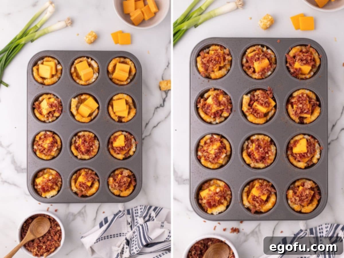 Smashed tater tot cups in a muffin pan, now filled with cubed cheese and crumbled bacon pieces.