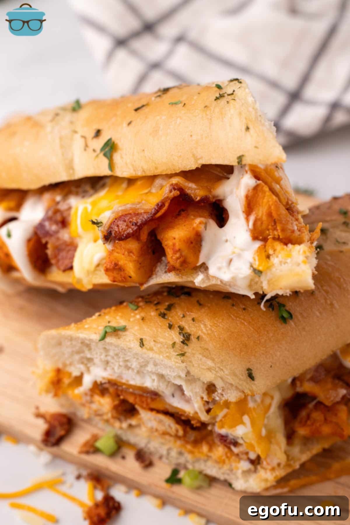 Loaded Chicken Bacon Ranch Baked Subs 2 A Chicken Bacon Ranch Baked Sub cut in half in a small stack.