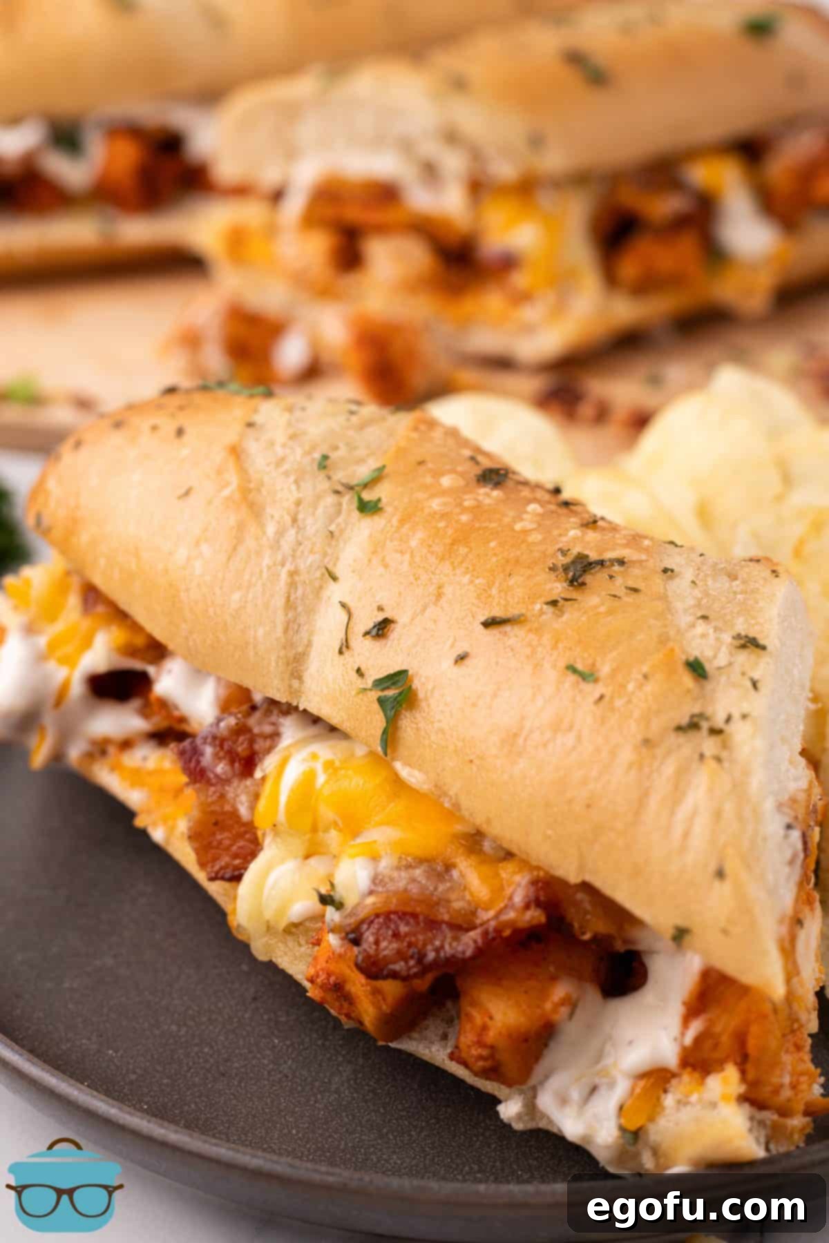 Loaded Chicken Bacon Ranch Baked Subs 12 A few Chicken Bacon Ranch Baked Subs on a tray.