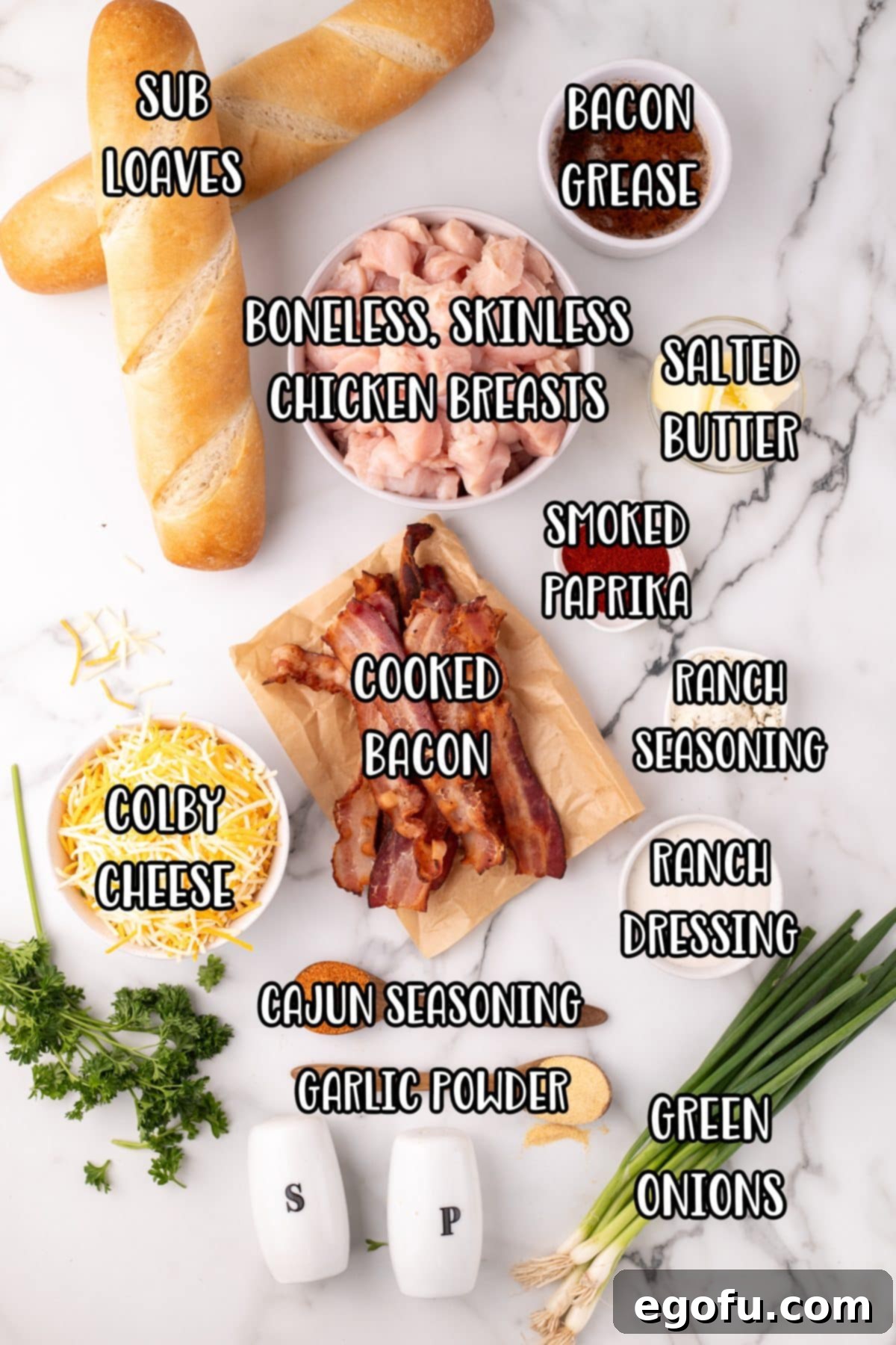 Loaded Chicken Bacon Ranch Baked Subs 4 French loaves, boneless skinless chicken breasts, cooked bacon, smoked paprika, salted butter, ranch seasoning, ranch dressing, Colby cheese, cajon seasoning, garlic powder, green onions, bacon grease, salt, pepper, and parsley.