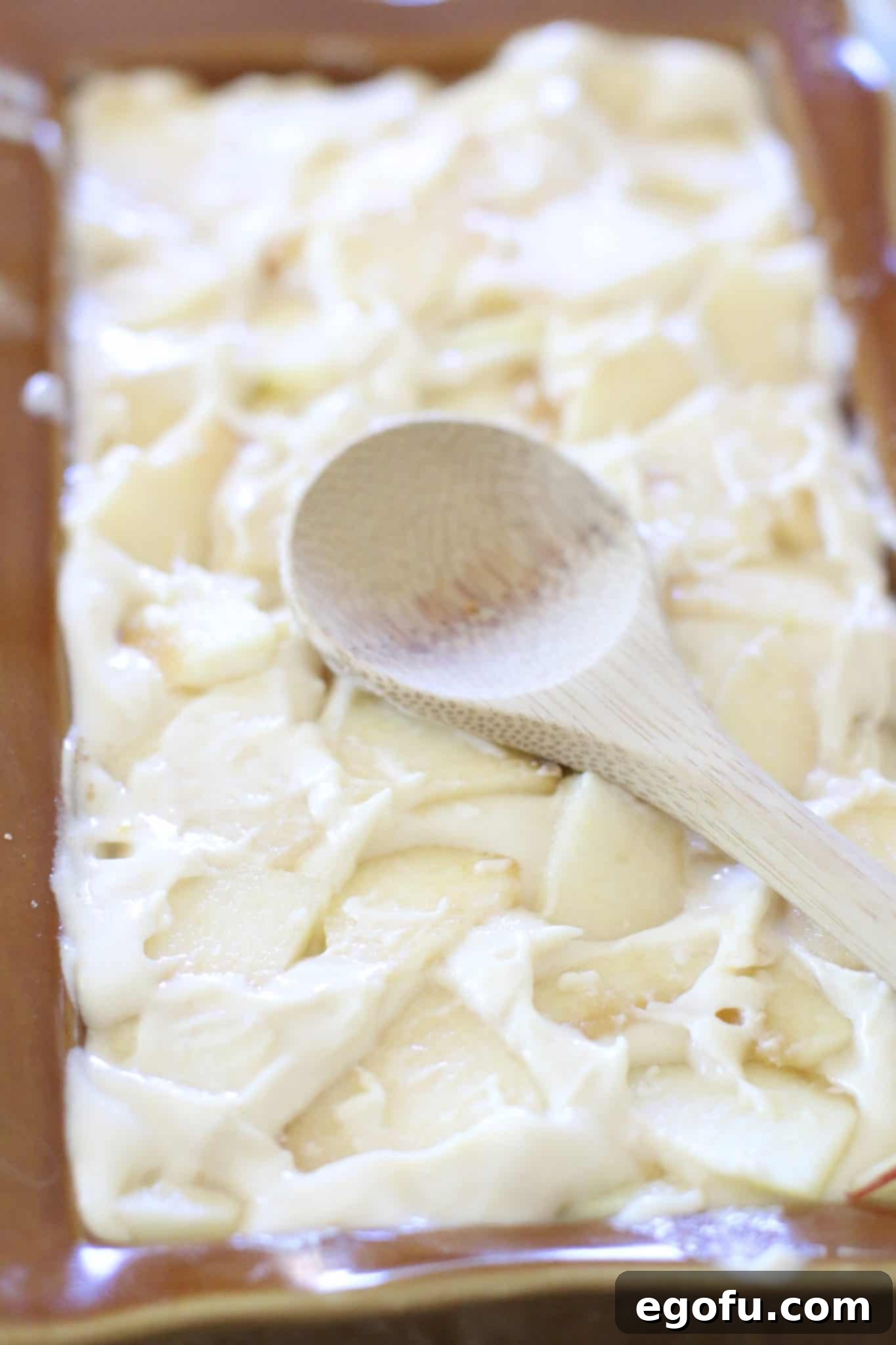 Final layer of chopped apples pushed into bread batter.