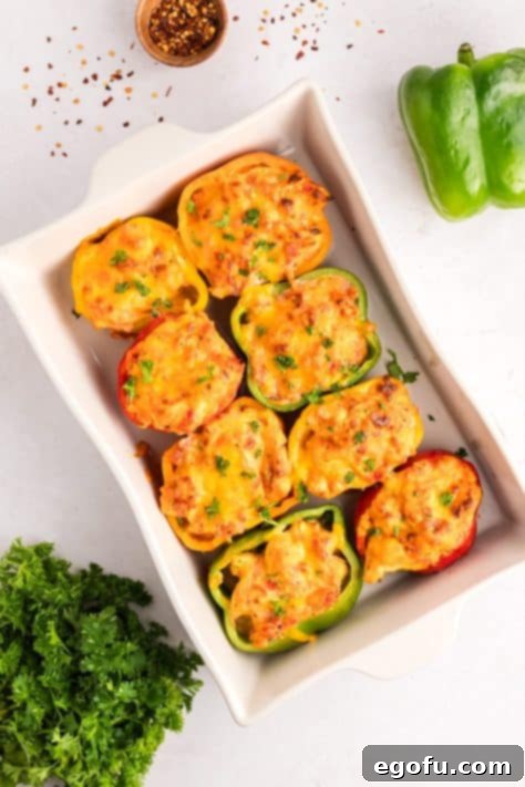 Savory Chicken Stuffed Bell Peppers 16 Baked Stuffed Peppers with a chicken mixture in a baking dish.
