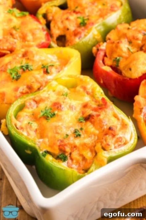 Savory Chicken Stuffed Bell Peppers 17 Looking down on a corner of a baking dish with lots of Stuffed Peppers with Chicken.
