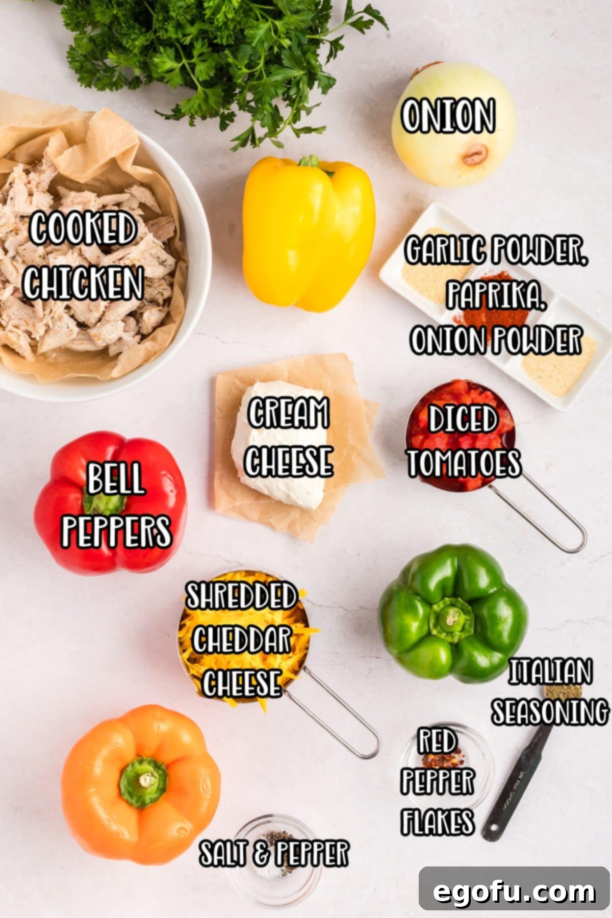 Savory Chicken Stuffed Bell Peppers 5 Orang bell pepper, red bell pepper, yellow bell peppers, green peppers, onions, parsley, chicken, shredded cheese, cream cheese, paprika, Italian seasoning, garlic powder, onion powder, black pepper, kosher salt, red pepper flakes, and petite tomatoes.