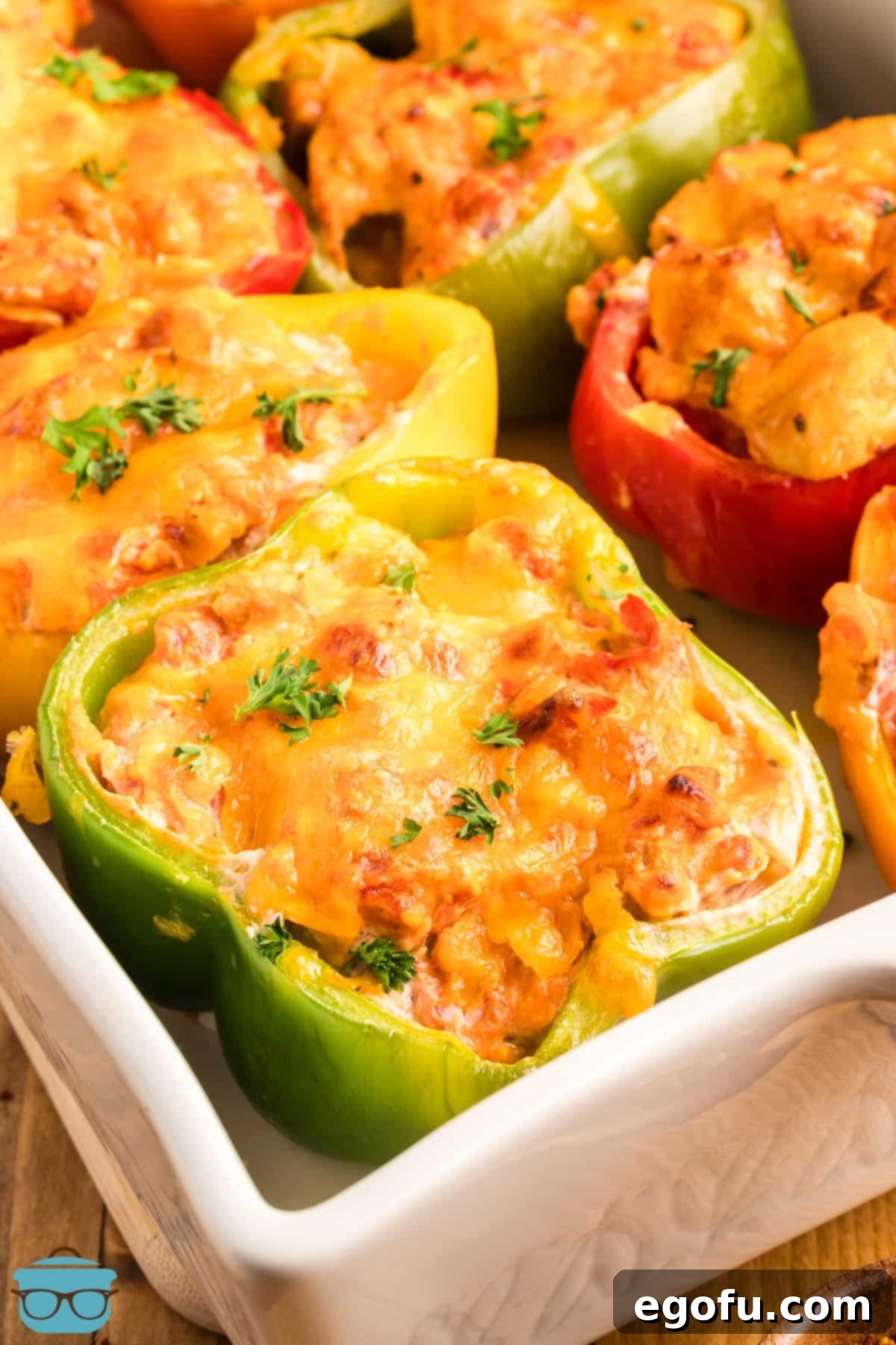 Savory Chicken Stuffed Bell Peppers 10 Looking down on a corner of a baking dish with lots of Stuffed Peppers with Chicken.
