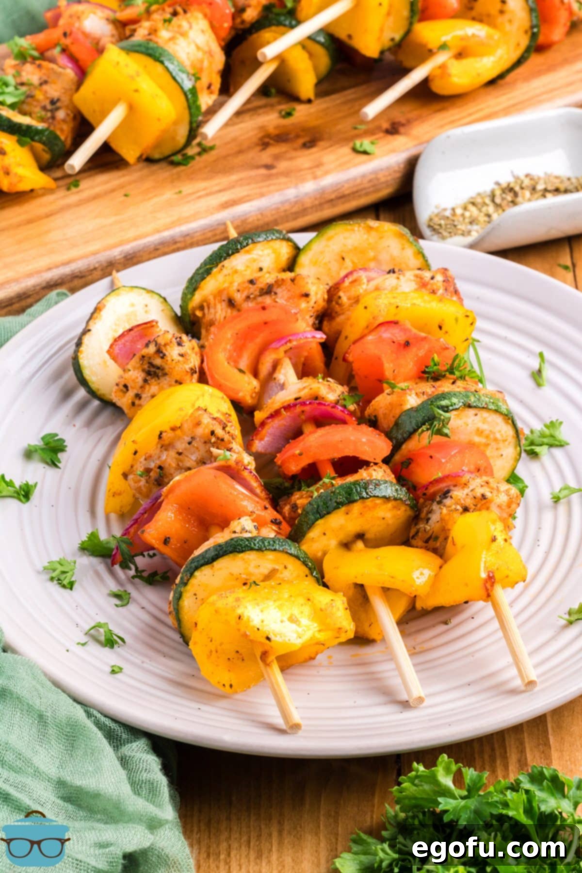 A plate with a few Baked Chicken Skewers, showcasing the tender chicken and colorful vegetables.
