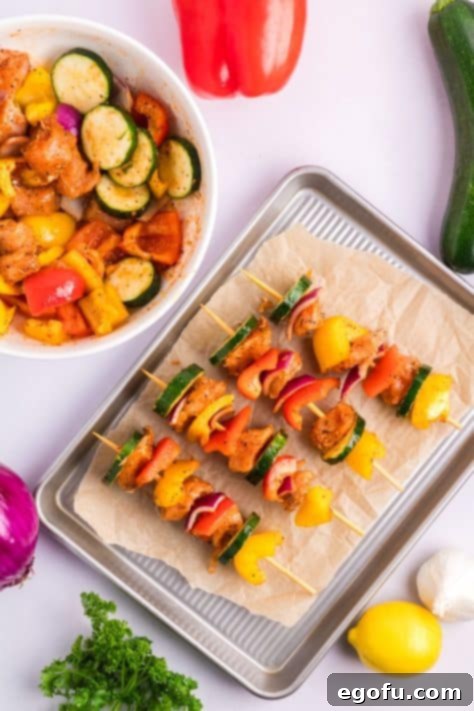 Assembled skewers on a baking sheet.