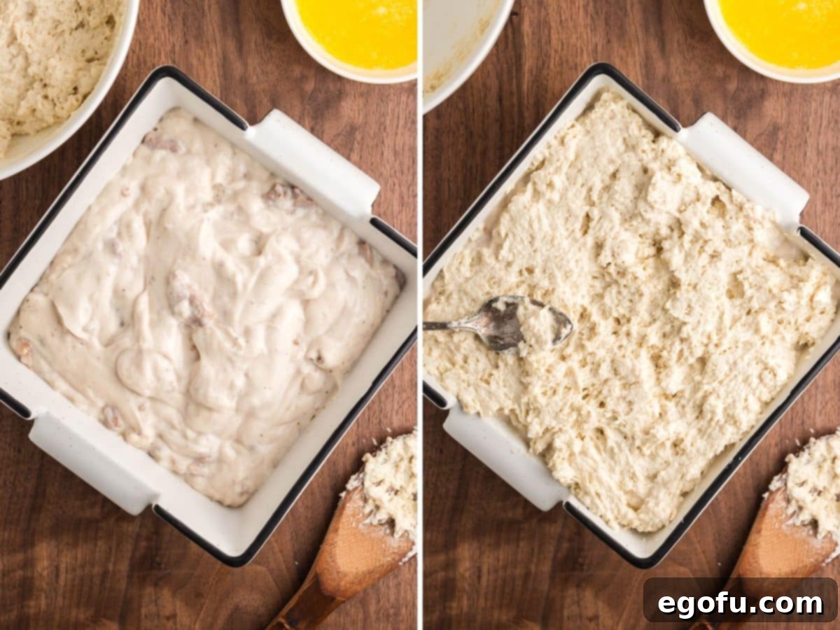 Sausage gravy in a baking dish with biscuit dough spread out over top.