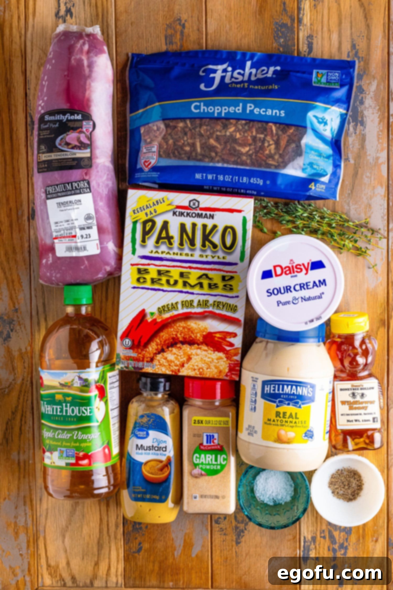 Pork tenderloin, thyme, mayo, sour cream, Panko breadcrumbs, olive oil, chopped pecans, salt, pepper, dijon mustard, apple cider vinegar, honey, and garlic powder.