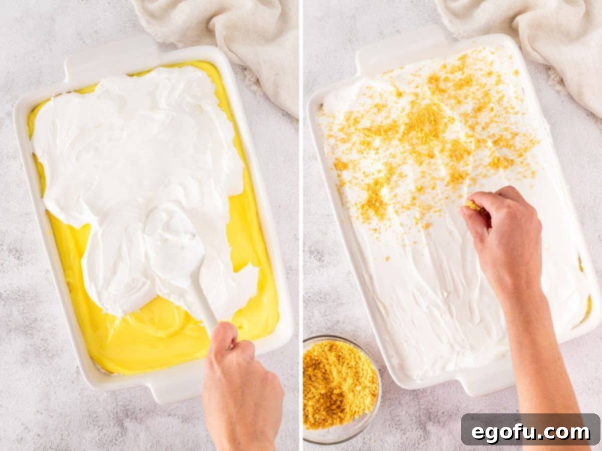 Cool Whip being spread over the lemon pudding layer, then sprinkled with crushed Lemon Oreo crumbs.