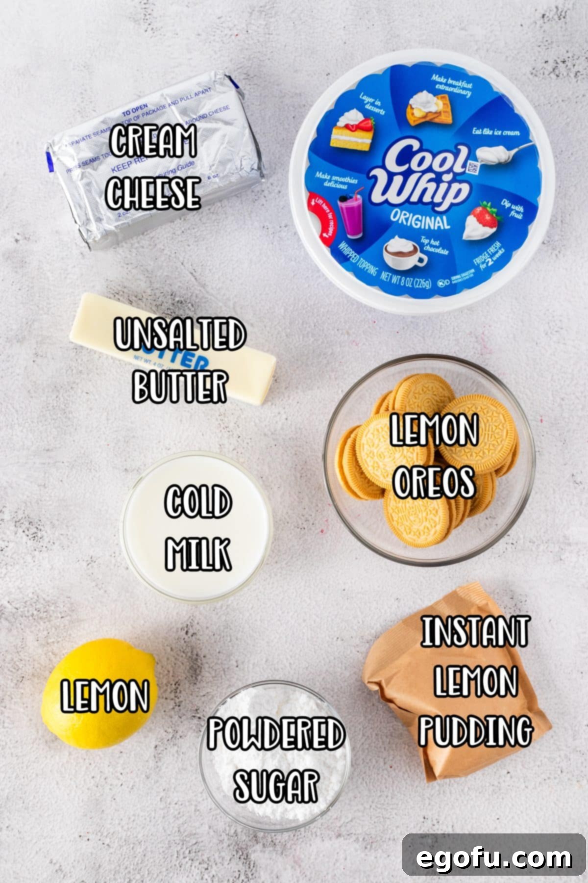 Cream cheese, Cool Whip, butter, fresh lemon juice, lemon zest, Lemon Oreos, Instant Pudding mix, and powdered sugar laid out as ingredients for Lemon Delight.
