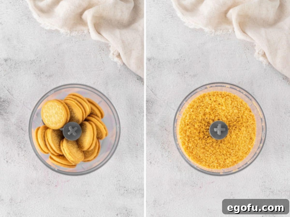 Lemon Oreos being crushed into fine crumbs in a food processor.