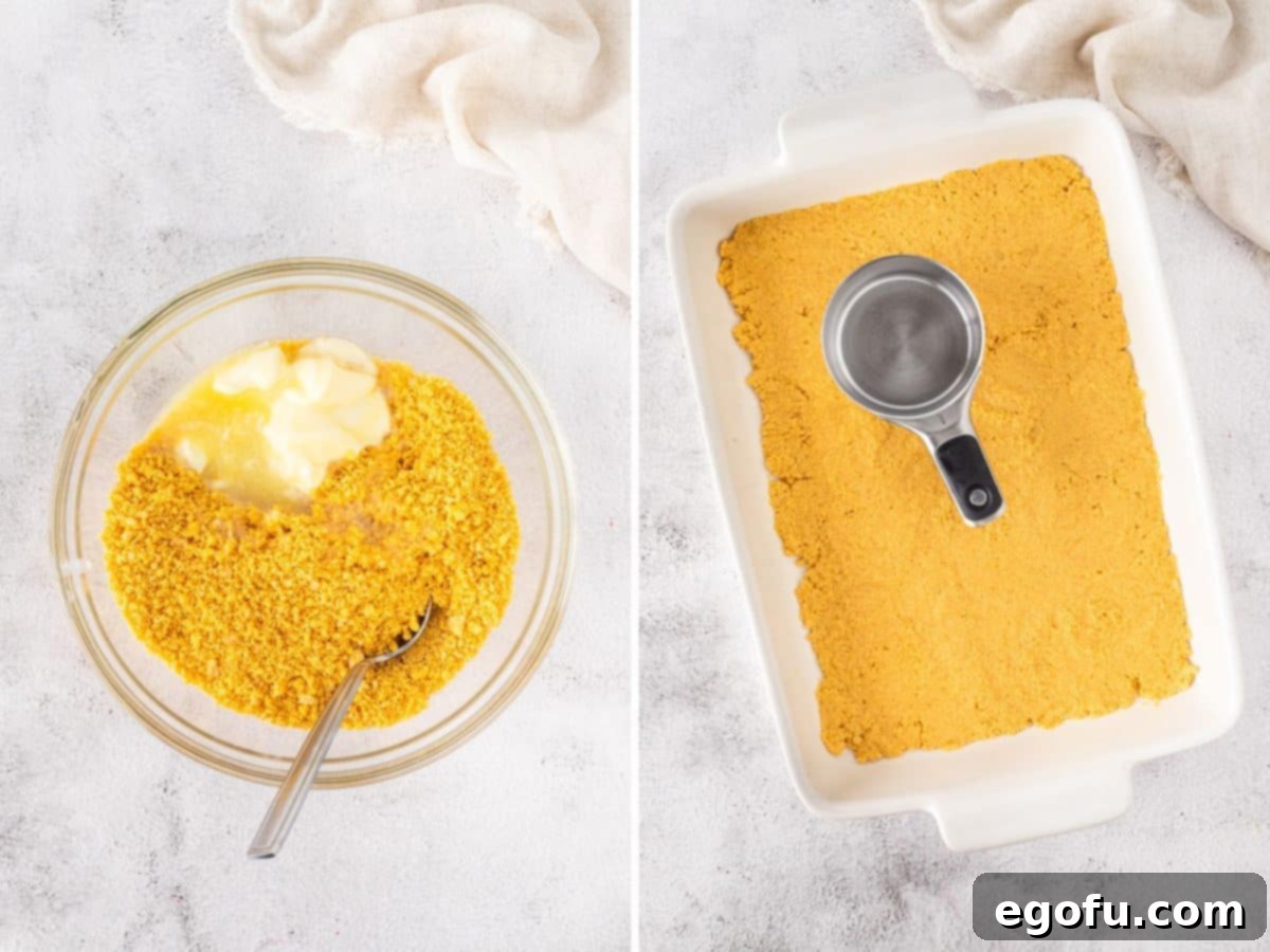 Lemon Oreo crumb mixture being pressed into the bottom of a baking dish to form the crust.