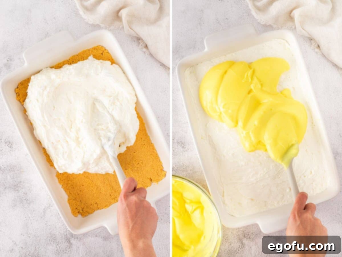 Lemon cream layer being spread over the crust, followed by the lemon pudding layer being spread over the creamy layer.