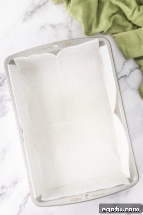 A baking dish lined with parchment paper.