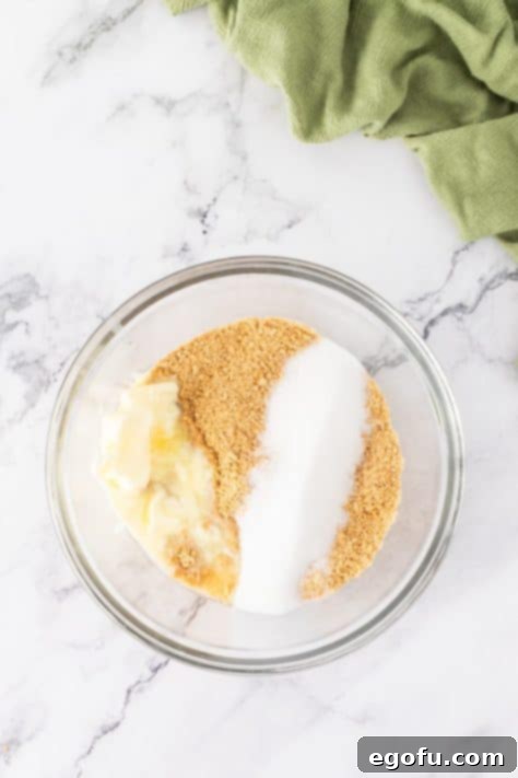 Graham cracker crumbs, sugar, and butter in a bowl.