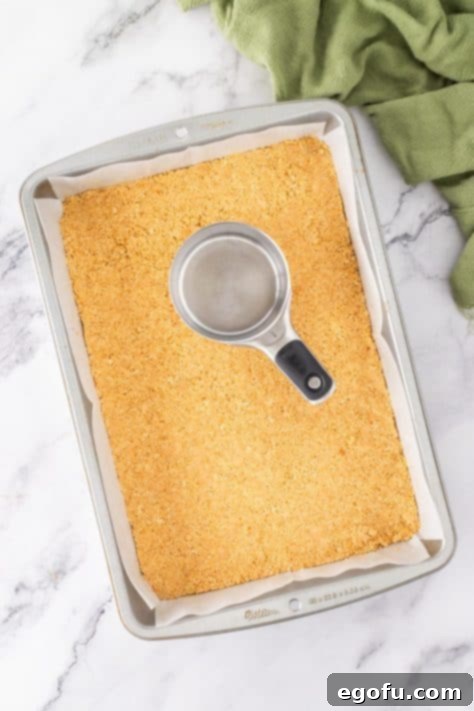 Graham cracker crumb crust in the bottom of a baking dish.