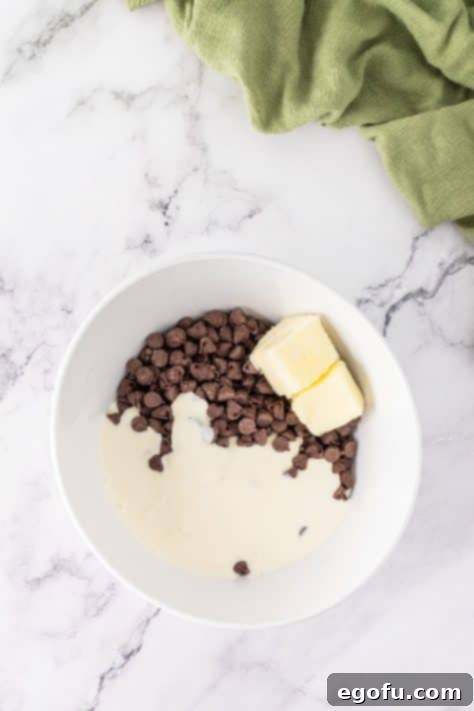 Chocolate chips, heavy cream, and butter in a mixing bowl.