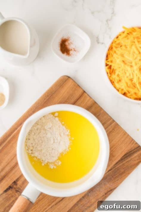 Melted butter and flour creating a roux in a saucepan.