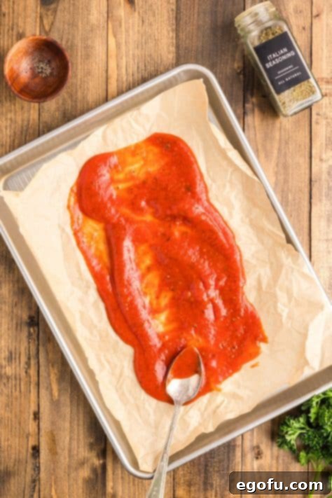 Grandma's Secret Italian Meatloaf 11 A lined baking sheet with marinara sauce.