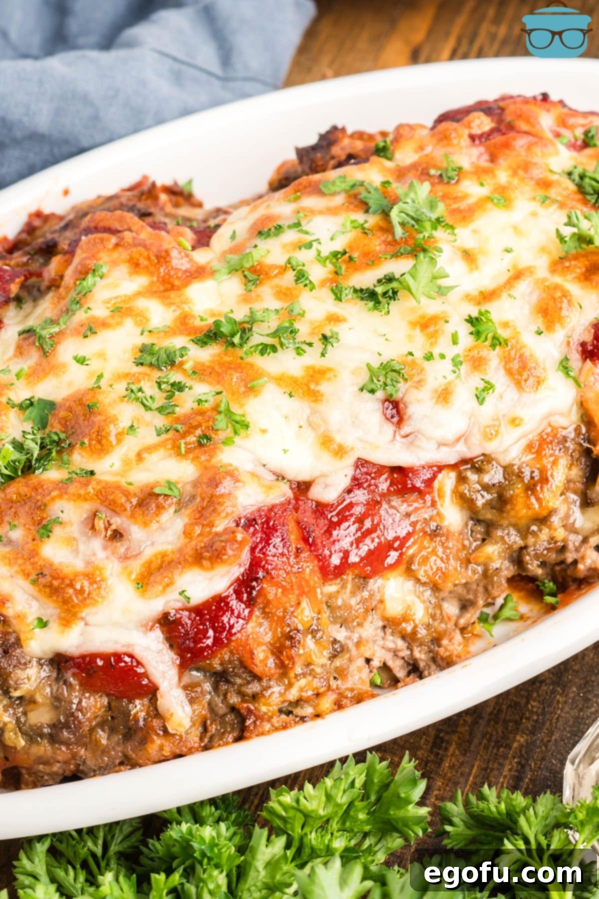 Grandma's Secret Italian Meatloaf 9 A full Italian Meatloaf, garnished with fresh parsley, presented in a serving container.
