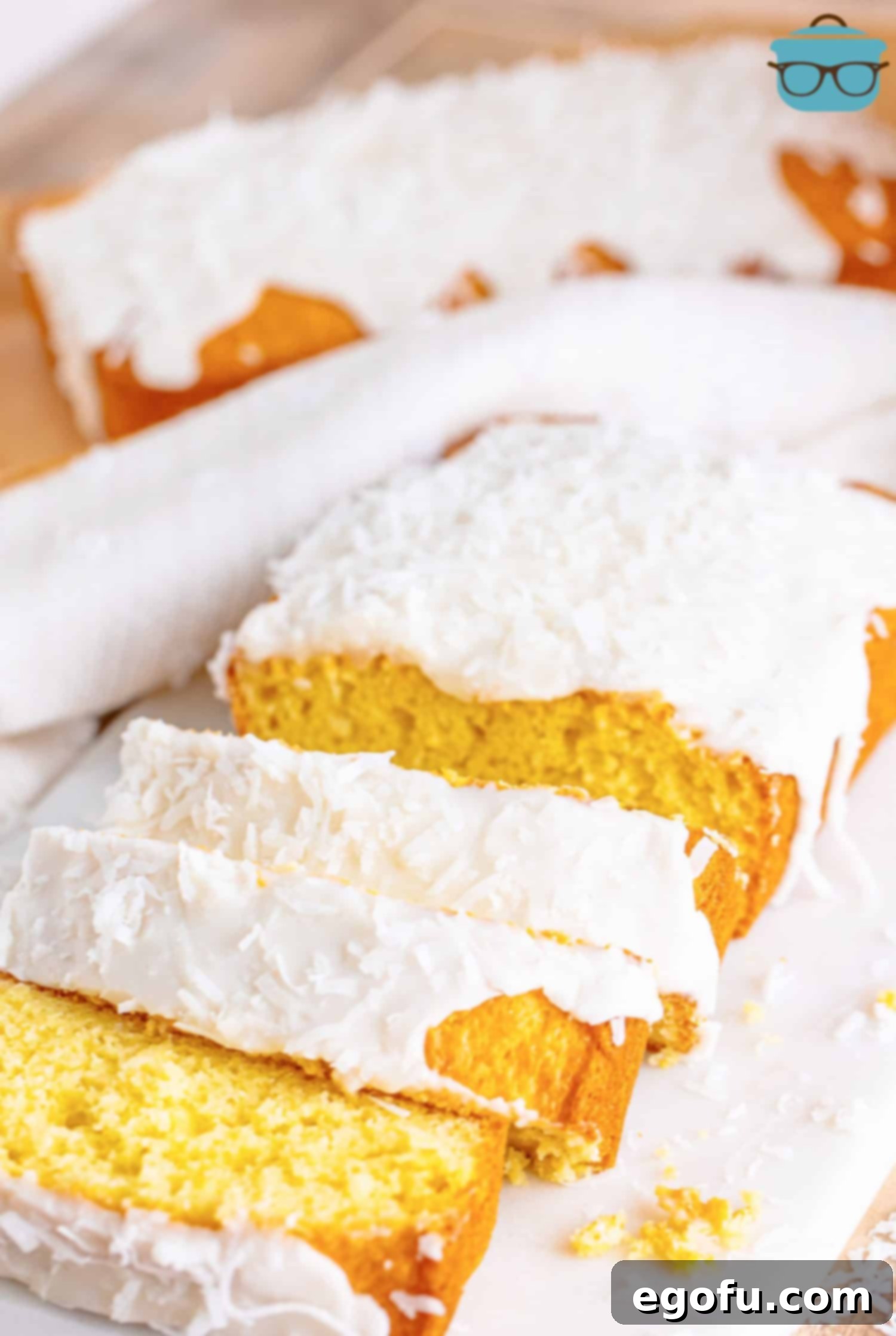 Tropical Coconut Bake 9 A few slices of Coconut Bread with the rest of the loaf and a full loaf in the back.