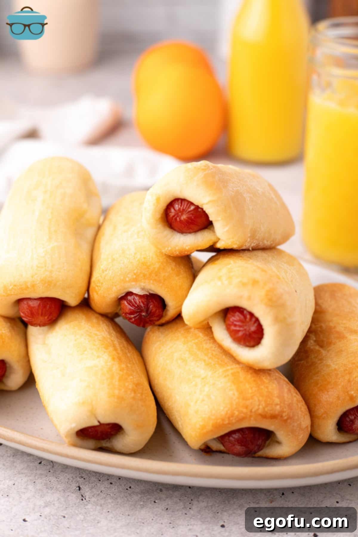 Hearty Texas Sausage Kolaches 2 A few homemade Sausage Kolaches on a plate, showcasing their golden-brown crust and inviting texture.