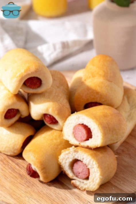 Hearty Texas Sausage Kolaches 17 A small pile of Sausage Kolaches on a cutting board.