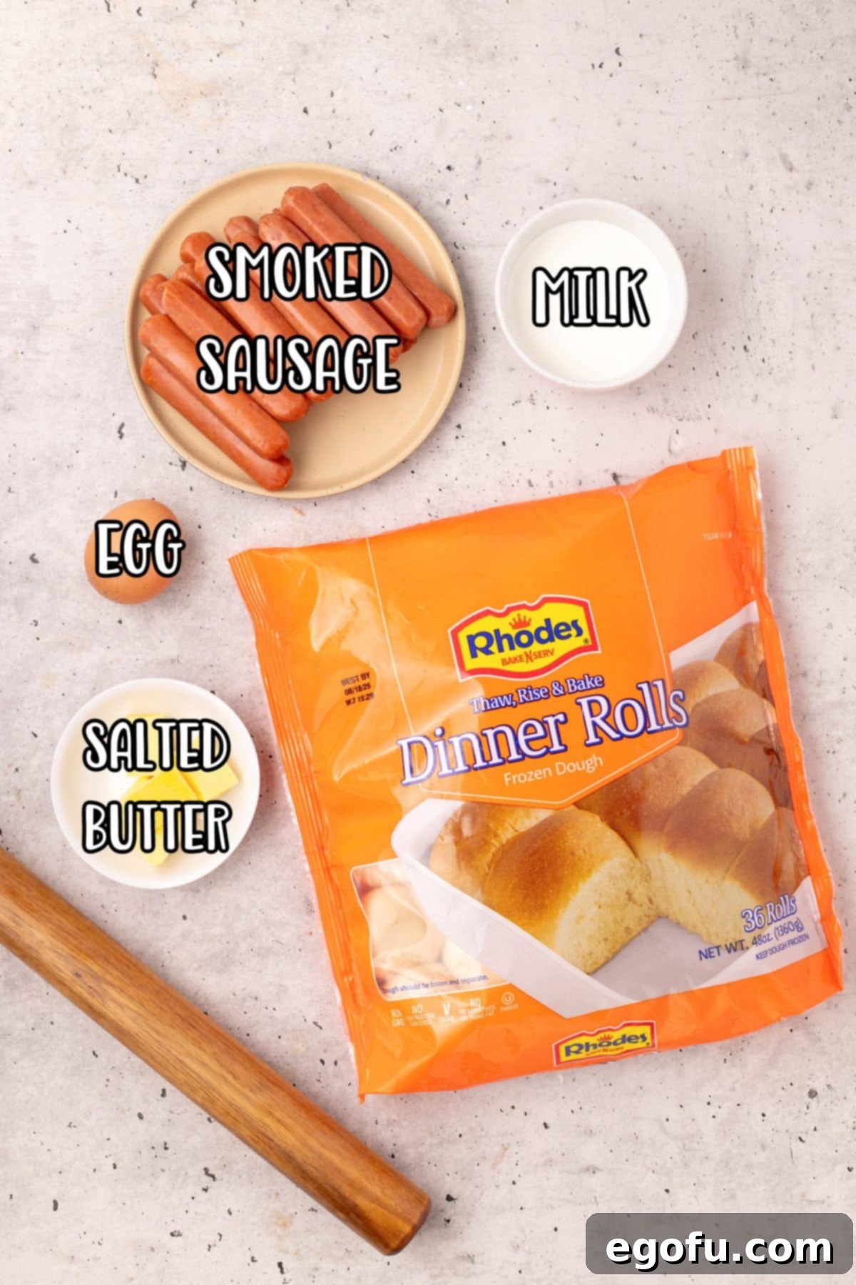 Hearty Texas Sausage Kolaches 4 A flat lay of the ingredients for Texas Sausage Kolaches: smoked sausage, milk, butter, egg, and a bag of dinner rolls.