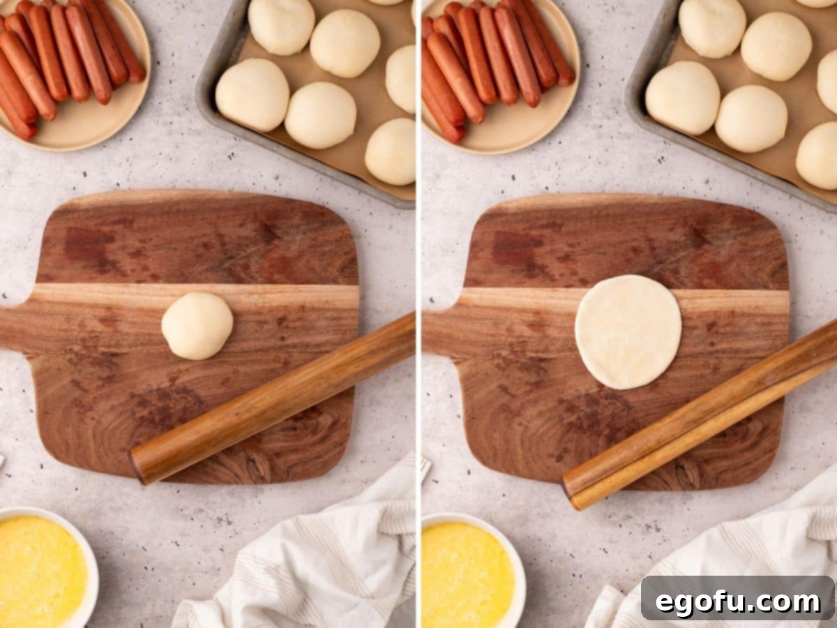 Hearty Texas Sausage Kolaches 6 A dinner roll dough piece rolled out into an oval shape on a wooden board.