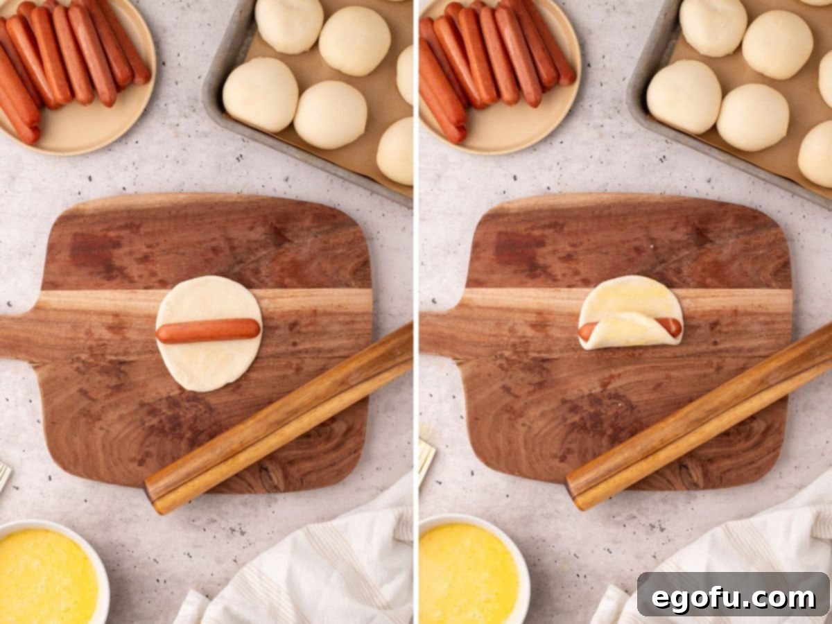 Hearty Texas Sausage Kolaches 7 A sausage being placed on dough, and then the dough being rolled up around the sausage.