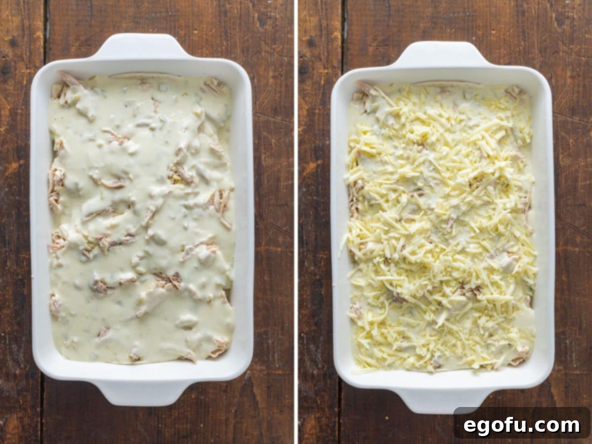 The layered casserole topped with shredded cheese, ready for baking.