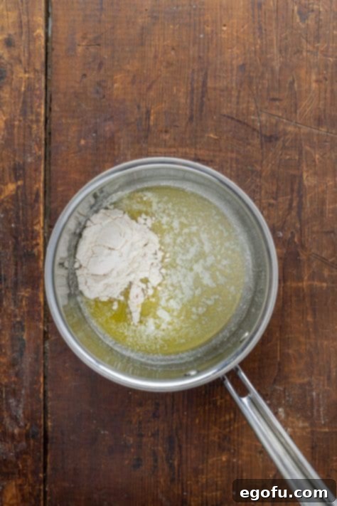 A pot with flour and melted butter creating a roux.