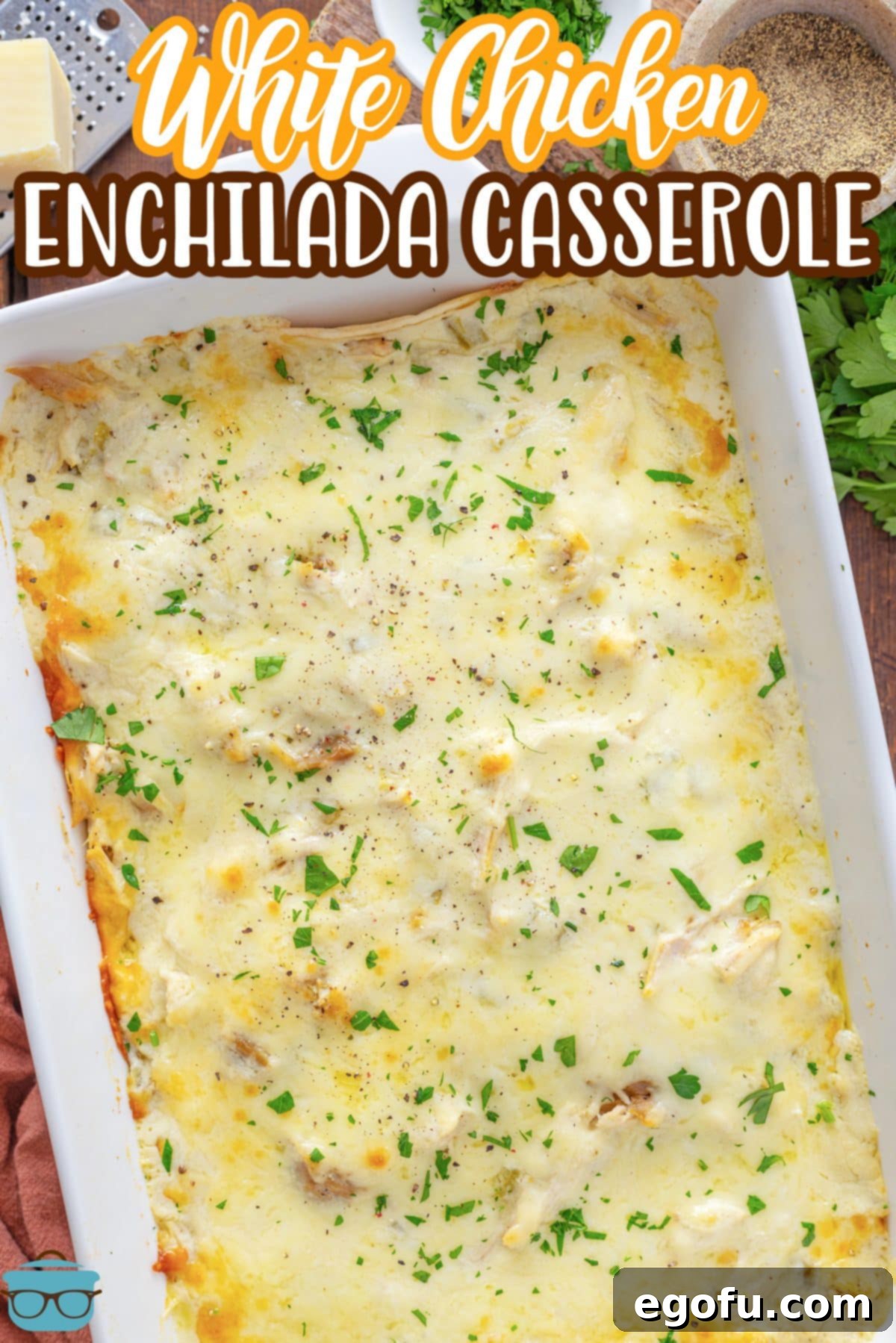 Looking down on a casserole dish with White Chicken Enchilada Casserole, ready to be served.