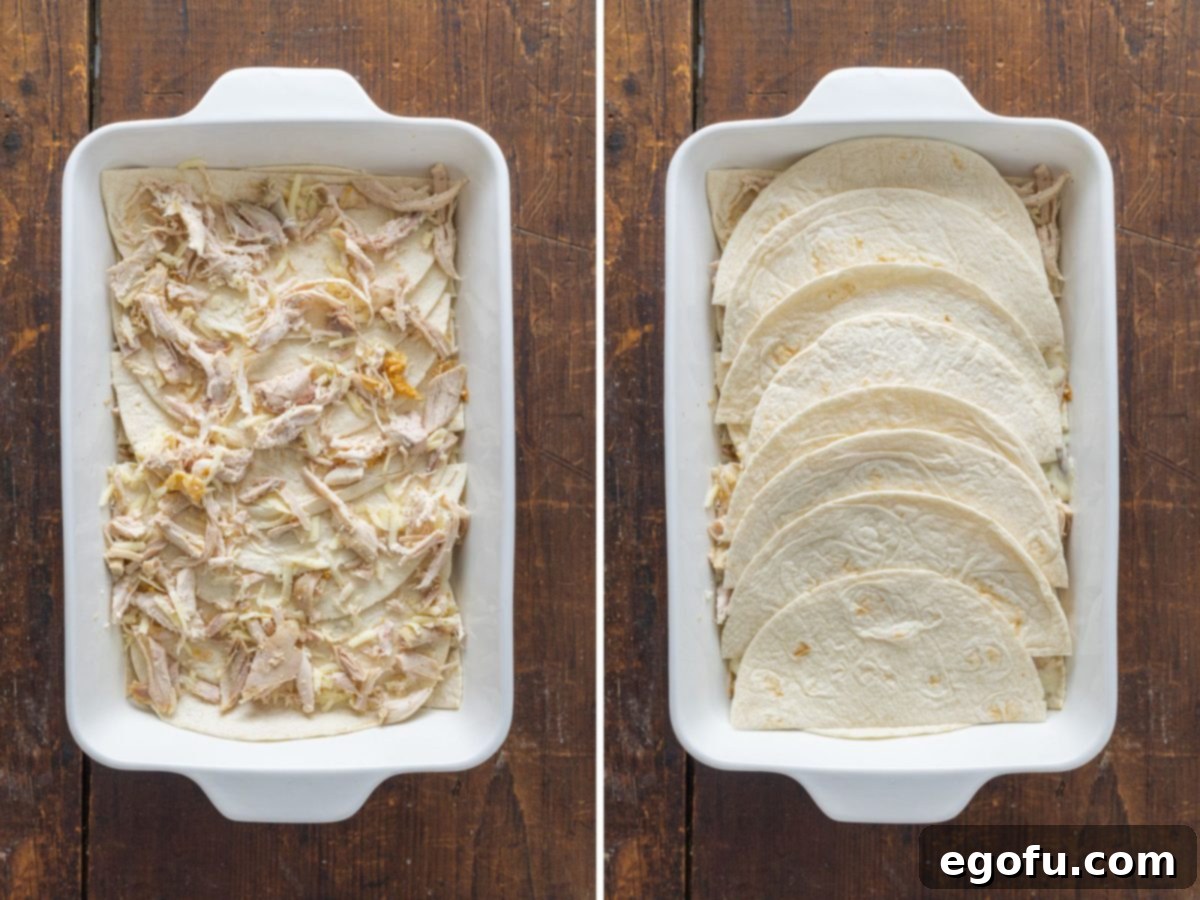 Further layers of sauce and chicken being added to the casserole, building up its delicious components.