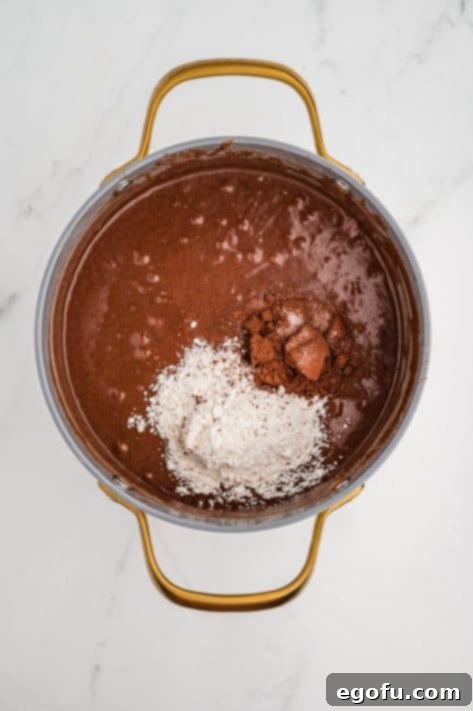 Rocky Road Bliss Bars 15 Salt, cocoa powder, and flour being added to a batter.