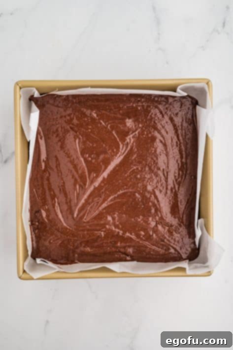 Rocky Road Bliss Bars 16 Brownie batter in a lined baking pan.