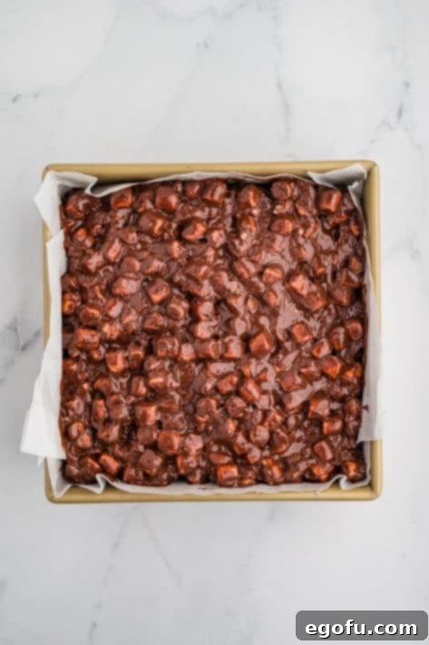 Rocky Road Bliss Bars 19 Chocolate marshmallow mixture over brownies in a pan.