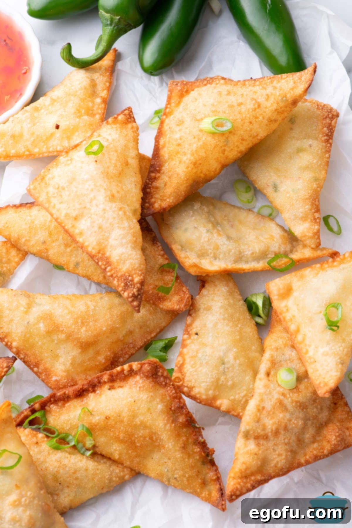 Crispy Jalapeño Wonton Poppers 11 A bunch of Jalapeno Popper Wontons on a plate.