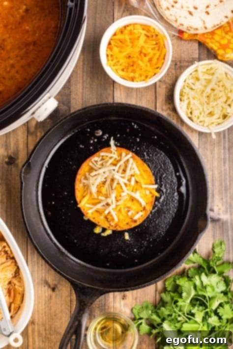 A cooked tortilla with shredded chicken.