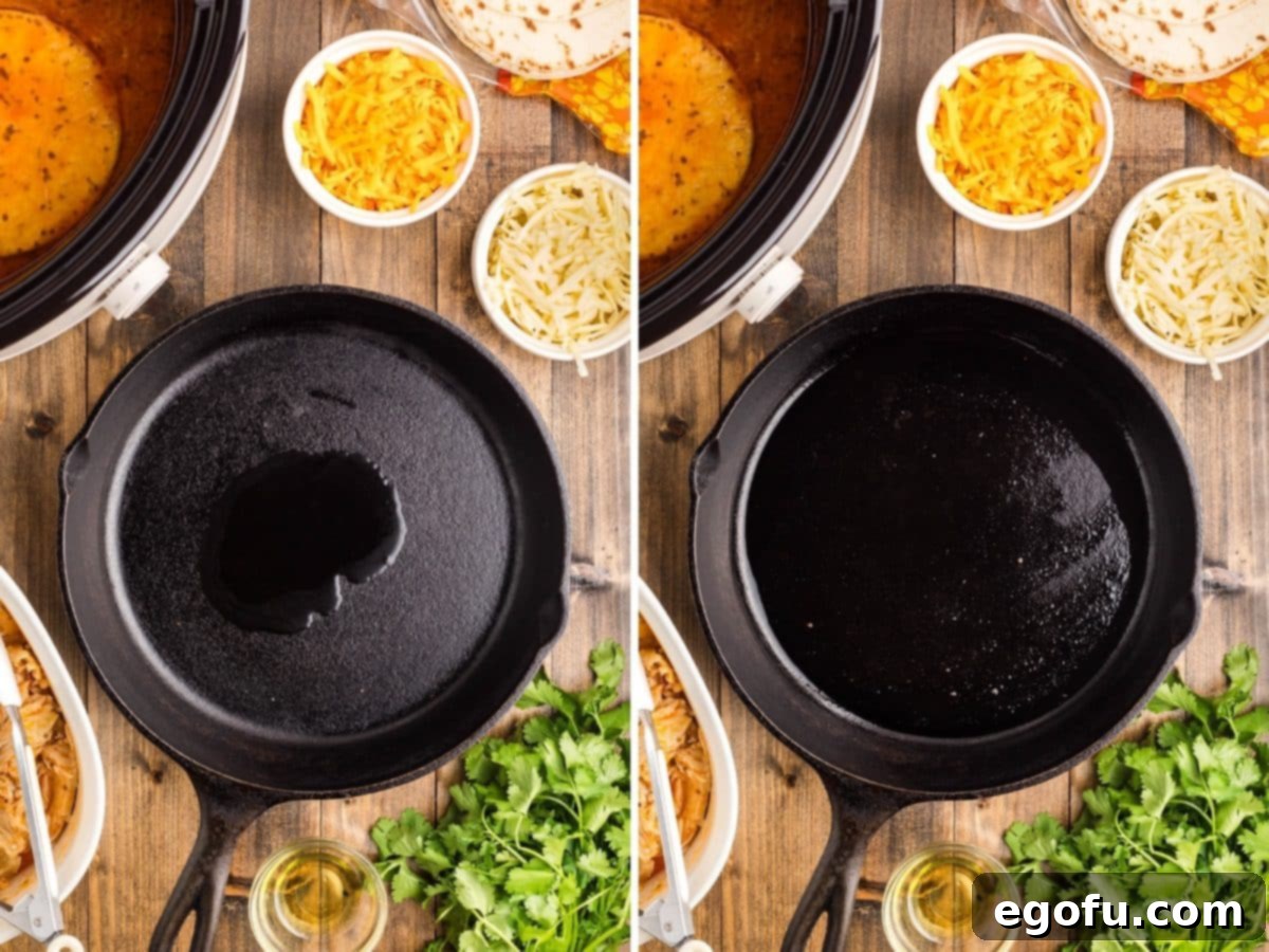 A non-stick skillet on a stovetop with a thin layer of olive oil coating the surface, ready for searing tortillas.