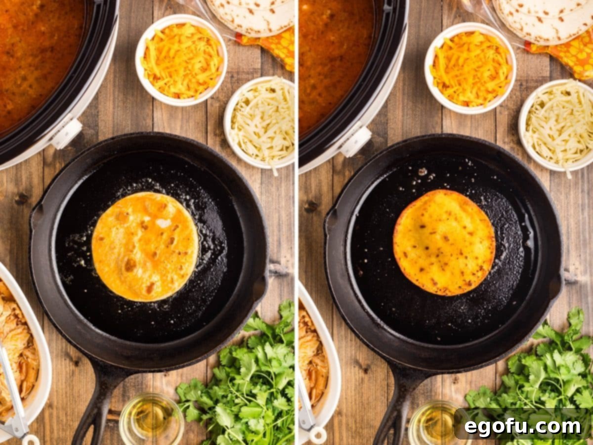 A street taco tortilla shell being cooked in a skillet, sizzling in oil and showing signs of golden browning.