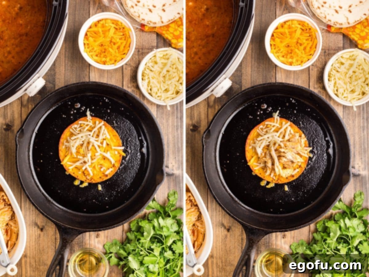 Shredded buffalo chicken and a generous amount of cheese being added to one half of a cooking tortilla shell in a hot skillet.