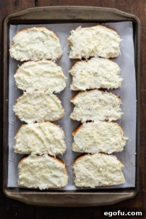 Bread that has butter and garlic cheese mixture spread over it.