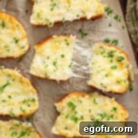 Closely looking down on a few slices of Pizza Hut Garlic Cheese Bread with one piece broken in half.