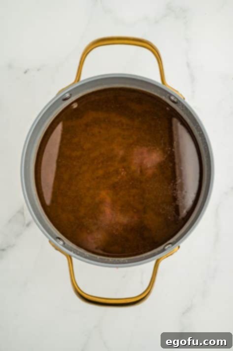 A large pot with a broth mixture.