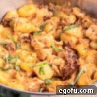 Looking closely at a skillet of Marry Me Chicken Gnocchi, ready to be served.