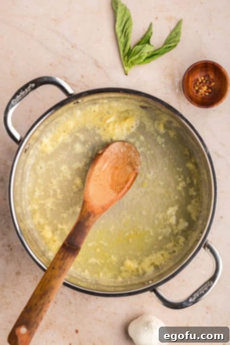 Chicken stock being added to skillet.