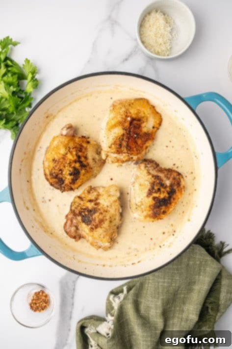 Creamy Garlic Chicken Delight 8 Seared chicken thighs returned to the skillet, now simmering gently in the rich, creamy garlic sauce.